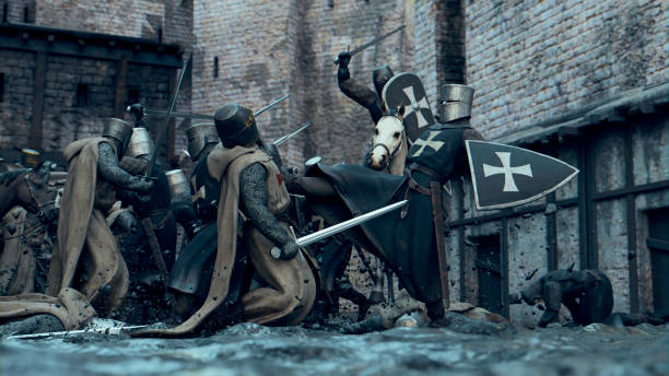 Lots of knights in armor fights with swords near a castle. Some rides horses. Some injured soldiers on the ground.